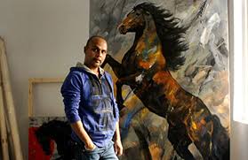 Devidas Dharmadhikari in his Pune studio with a large horse painting